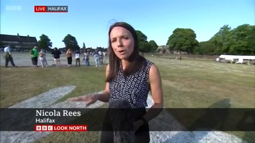 Still image of a female BBC News Presenter on Savile Park field