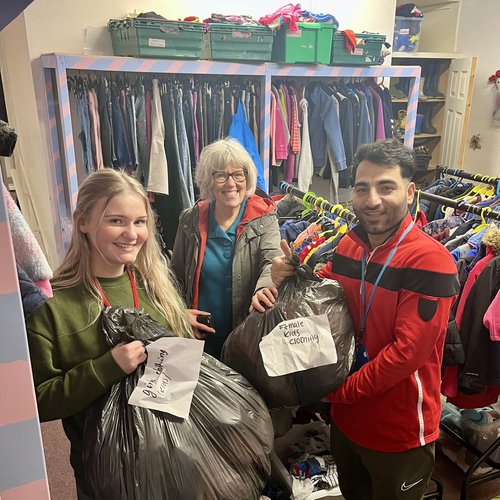 North Halifax Grammar School Sixth Form Charity Committee member Lily, Miss Keeler and Mr Stefanakis delivered 76 big bags of clothes.